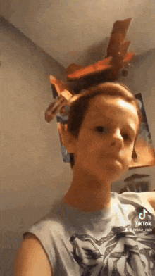 a young boy with a bunch of chips on his head