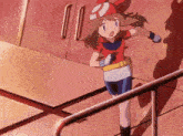 a girl in a red shirt with the letter r on it is standing next to a railing