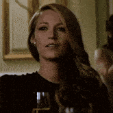 a woman sitting at a table with a glass of champagne