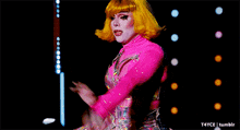 a woman in a pink dress and white boots is dancing on a stage with t4yce tumblr in the corner