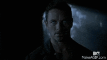 a man is being choked by a monster in a dark cave .