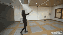a woman is dancing in an empty room with the words made in animotica on the bottom