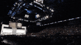 a large screen with roh wrestling written on it hangs over a crowd