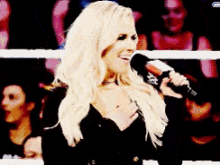 a blonde woman is singing into a microphone with a x on it