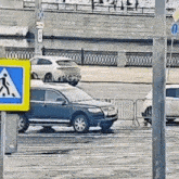 a couple of cars are parked on the side of the road next to a yellow sign .