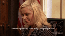 a woman in a polka dot shirt is saying i 'm feeling a lot of confusing things right now