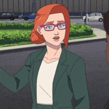 a woman with red hair and glasses is wearing a green jacket and white shirt