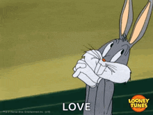 bugs bunny from looney tunes is holding his arms crossed and says `` love '' .