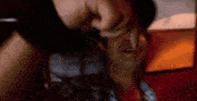a man is being punched in the face by another man in a room .