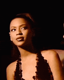 a woman in a sequined top is standing next to another woman in a bikini