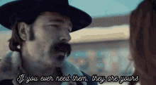 a man with a mustache is talking to a woman with the words if you ever need them they are yours below him