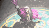 a woman in a pink feathered outfit stands in a circle with the letter m on it