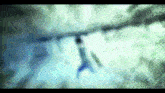a blurry picture of a person 's face with a t on it