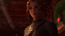 a woman with red hair is standing in front of a green machine with a red light on it