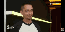 a man in a black and white shirt is on a screen that says ' interoplay ' on it