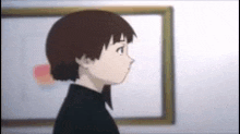 a girl is standing in front of a picture frame in a room .