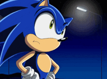 sonic the hedgehog is standing in front of a street light at night