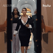 a woman is walking down a hallway with the words all 's fair on the bottom