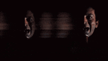 a blurry photo of a man singing into a microphone with the letters x on it