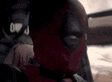a close up of a person wearing a deadpool mask
