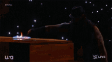 a man with a beard is standing in front of a box of fire .