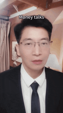 a man in a suit and tie with the words money talks above his head