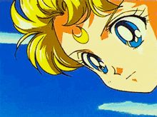 a close up of a girl 's face with a blue sky in the background .