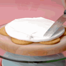 a person is spreading frosting on a plate of cookies with easy plus written on the bottom