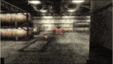 a red race car is driving through a warehouse