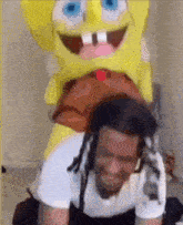 a man is riding on the back of a stuffed spongebob squarepants .