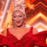 a woman in a red dress with a star on the bottom right
