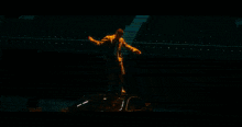 a man in a mask is standing in front of flames