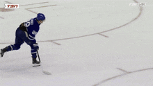 a hockey goalie stands on the ice in front of a banner that says canada scott