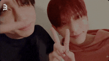 two young men are making a peace sign with their fingers