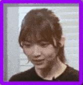 a close up of a woman 's face with a purple border around it .