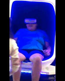 a person is wearing a virtual reality headset while sitting in a chair