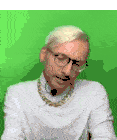 a man wearing glasses and a gold chain around his neck against a green background