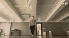 a man wearing a mask is dancing in a room with a piano .