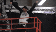 a man with his arms in the air is wearing a shirt that says ' i love you '