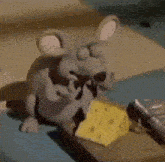a cartoon mouse is eating cheese on a mouse trap