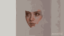 a person is painting a woman 's face on a canvas with a brush .