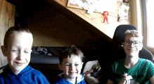 a boy wearing glasses and a green shirt that says ' i love you '