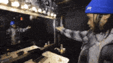 a man in a blue hat with the letter s on it
