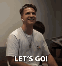 a young man says let 's go with a smile on his face