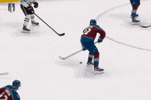 a hockey player with the number 92 on his jersey is flying through the air