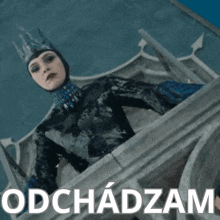 a woman with a crown on her head stands on a balcony with the word obchodzam written below her