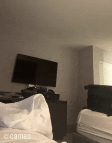 a hotel room with a cameo logo on the bottom right