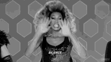 a black and white photo of a drag queen screaming and shouting .