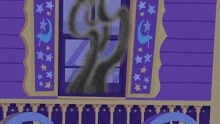a blue pony wearing a hat with stars on it looks out of a window