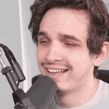 a close up of a man 's face with a microphone that says ' pro ' on the bottom